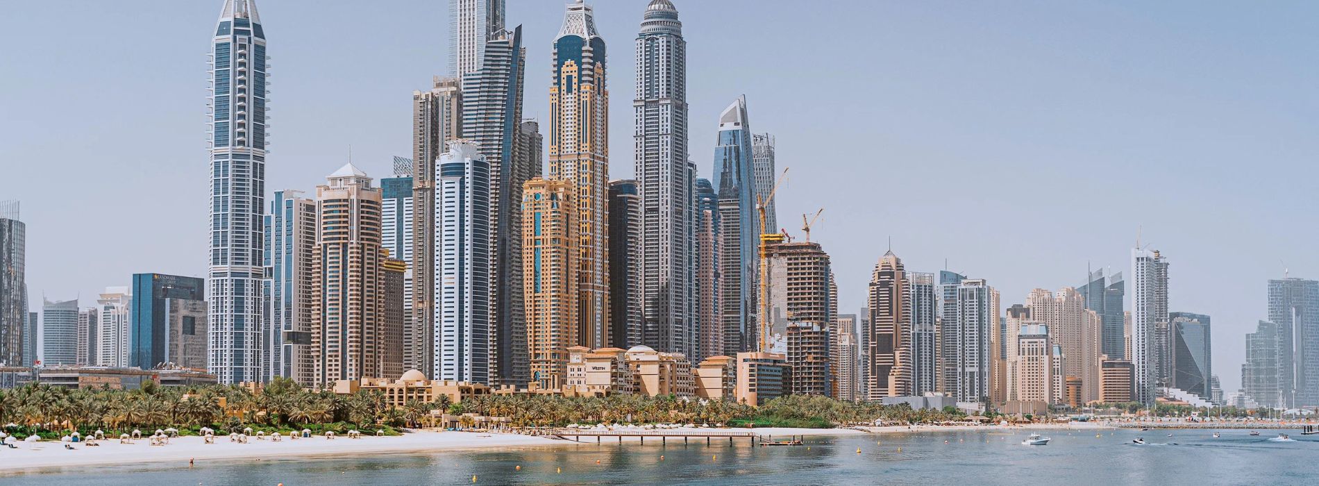 How can expats buy their own property in Dubai?